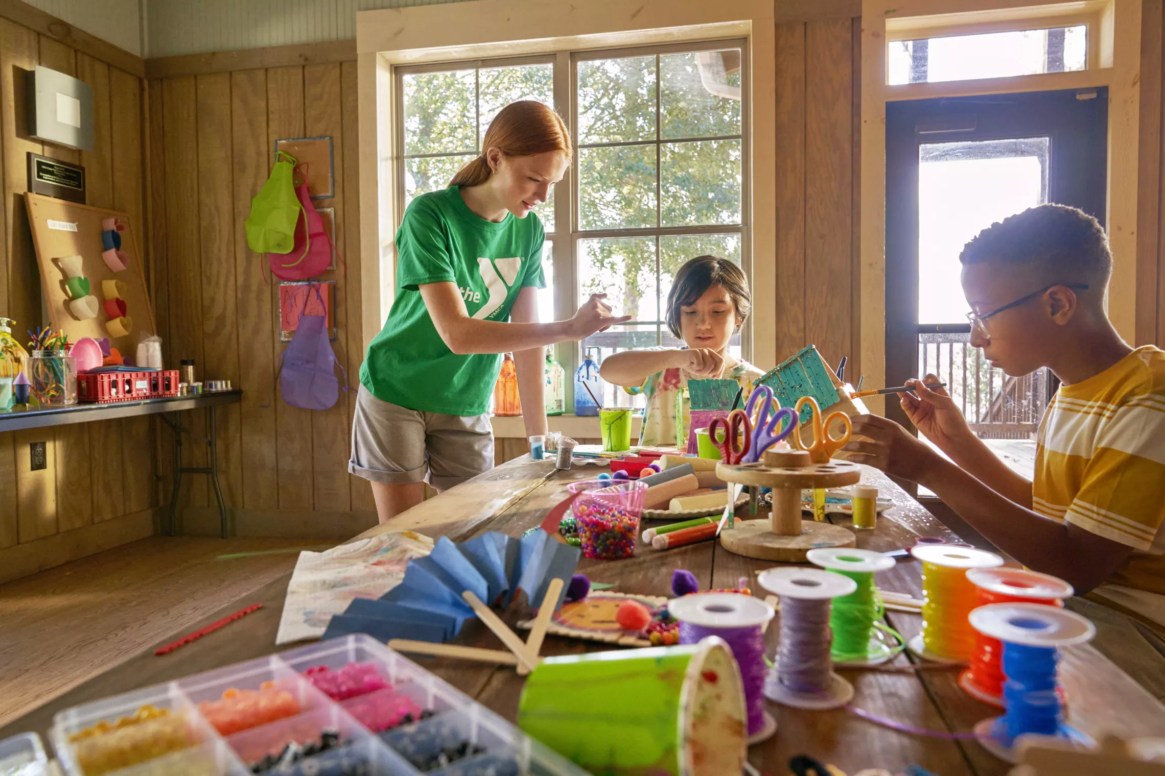 Kids and staff doing arts and crafts